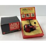 A boxed vintage Swedish ABU-505 closed face fishing reel in red chrome and black finish. Donated