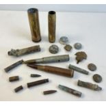 A collection of military metal detector finds. To include cap badges, shell cases and buttons.