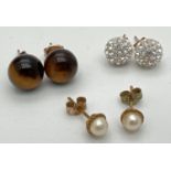 3 pairs of 9ct gold and yellow metal stud style earrings. Tigers eye, crystal studded balls and