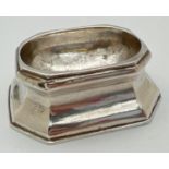 A George I silver trencher salt of octagonal form raised on a tapered base. Partially rubbed