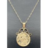 A 9ct gold St. George medallion pendant in scroll design mount, on an 18" fine belcher chain with
