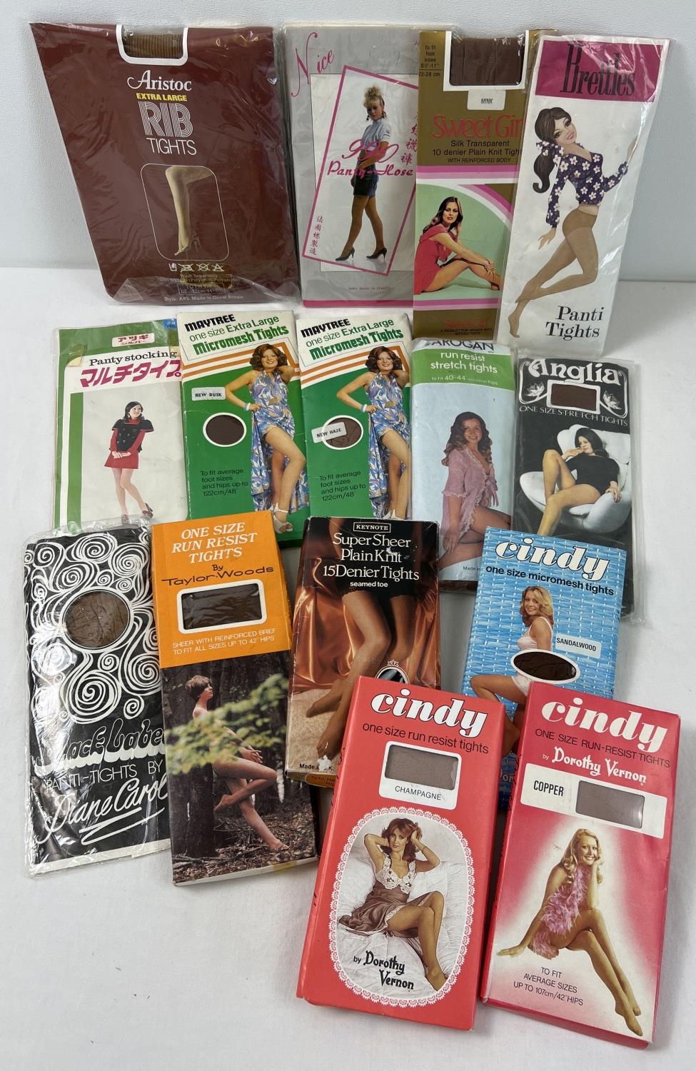 15 assorted vintage pairs of tights, in original packaging, in varying styles and colours. To