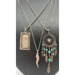 3 silver and white metal pendants on silver chains. A Dream catcher pendant with turquoise beads