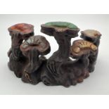 A Chinese bronze Scholars rock modelled as a cluster of mushrooms, set with natural stone panels.