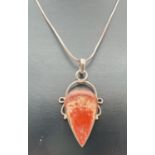 A modern design drop pendant set with red/brown jasper, on a 16" box snake chain with lobster claw