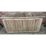 A 'Deuba' slatted wood garden storage box with movable panels to base. Approx. 58cm tall x 117cm