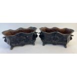A pair of antique cast iron footed planters, painted black with floral & swag detail. Each approx.
