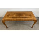 A vintage light wood coffee table, marquetry design to top with stag detail. Raised on cabriole