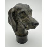 A vintage hollow bronze walking cane handle modelled as a dogs head. Approx. 7cm long.
