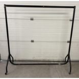 Heavy duty black coloured metal framed clothes rail on wheels. Approx. 155cm tall x 153cm long.