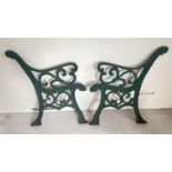 A pair of heavy cast iron bench ends, painted green with scroll design. Approx. 78cm x 70cm.