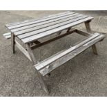 A wooden slatted 6 seater picnic bench.
