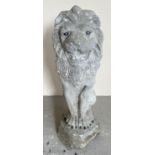 A large concrete garden ornament modelled as a lion. Approx. 55cm tall.