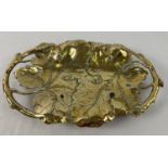 A brass Art Nouveau design shallow bowl modelled as vine leaves with pierced detail to handles.