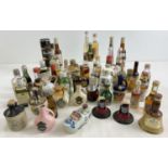 A collection of 49 assorted vintage alcohol miniatures to include novelty examples. Lot includes