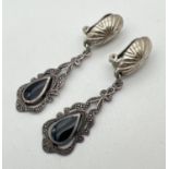 A pair of silver drop style clip on earrings. Each set with a teardrop of black onyx in a Gothic