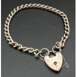 A vintage silver 7.5" curb chain bracelet with padlock clasp and safety chain. Lion passant