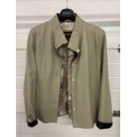 A pale sage green soft leather jacket by Alji Piel. Button front with front slant pockets and turn