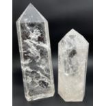 2 large clear crystal quartz obelisk wand points with natural clear and white formations. Largest