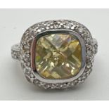 A silver, lemon quartz and cubic zirconia cocktail ring with central cushion cut stone. Surrounded