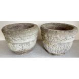 A large pair of vintage concrete circular shaped garden planters with panelled floral design.