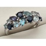 A 9ct white gold dress ring set with marquise and round cut, blue topaz, aquamarine and iolite