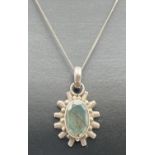 A sun-ray design oval shaped pendant set with labradorite, on a 16" fine curb chain with spring ring