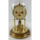 A vintage brass anniversary clock by Kundo W. Germany with glass dome. Floral detail to face with