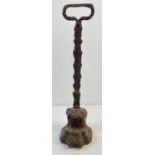A Victorian long handled metal door stop in the shape of a lions paw. Approx. 38.5cm tall.