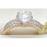 A new with tags 14kt gold plated cocktail ring set with Swarovski crystals. Central round cut