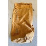 A large orange/brown canvas Seaman's kit bag with rope drawstrings. Stamped inside and dated 1980.