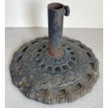A cast iron circular shaped garden parasol stand with floral design. Approx. 43.5cm diameter.