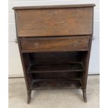 A vintage dark wood bureau with undershelf and drawer. Interior stationary compartments to top