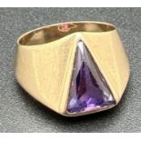 A modern design 10k gold chunky ring set with triangular shaped purple sapphire stone. Stamped '