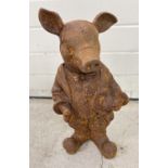 A large rusted cast iron figure of a pig in a suit. Approx. 43cm tall.