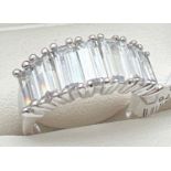 A Rhodium plated cocktail ring set with Swarovski crystals. Band style ring set with 7 baguette