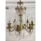 A vintage 8 arm brass and crystal chandelier ceiling pendant, with electrical wiring. Crystal