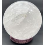 A large 15kg clear rock crystal (clear Quartz) sphere with white and rainbow colours to natural