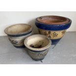 3 modern garden planters of varying sizes, blue banded glaze with floral details. Largest pot has