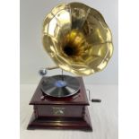 A reproduction wooden cased table top, wind up, trumpet gramophone marked "His Masters Voice". In