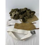 A small collection of military belts and canvas leg gaiters.