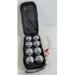 A cased set of chrome plated garden Boules, complete with instructions, marker & piglet. In a