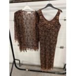 A lace sleeveless dress and matching open fronted jacket in orange and black, by Ann Balon, size L.