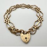 A 9ct gold vintage 3 bar gate style bracelet with padlock clasp and safety chain. Gold marks to back