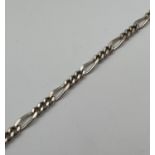 An 8.5 inch Figaro chain bracelet with spring ring clasp. Silver marks to clasp. Total weight