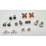 8 pairs of stone set silver and white metal earrings in both stud and drop styles. For pierced ears,
