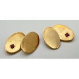 A pair of vintage 9ct gold plain oval cufflinks set with a small ruby to each, by Britannic. Name