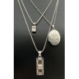 3 silver pendant necklaces. A square cut clear stone pendant on a 16" box chain; an oval shaped