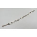 A Fossil silver bracelet with teardrop shaped links and lobster claw clasp. Approx. 7.5 inches long.