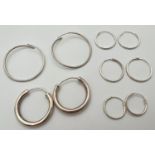 5 pairs of silver hoop earrings in varying sizes. Largest pair approx. 3cm diameter. All have silver